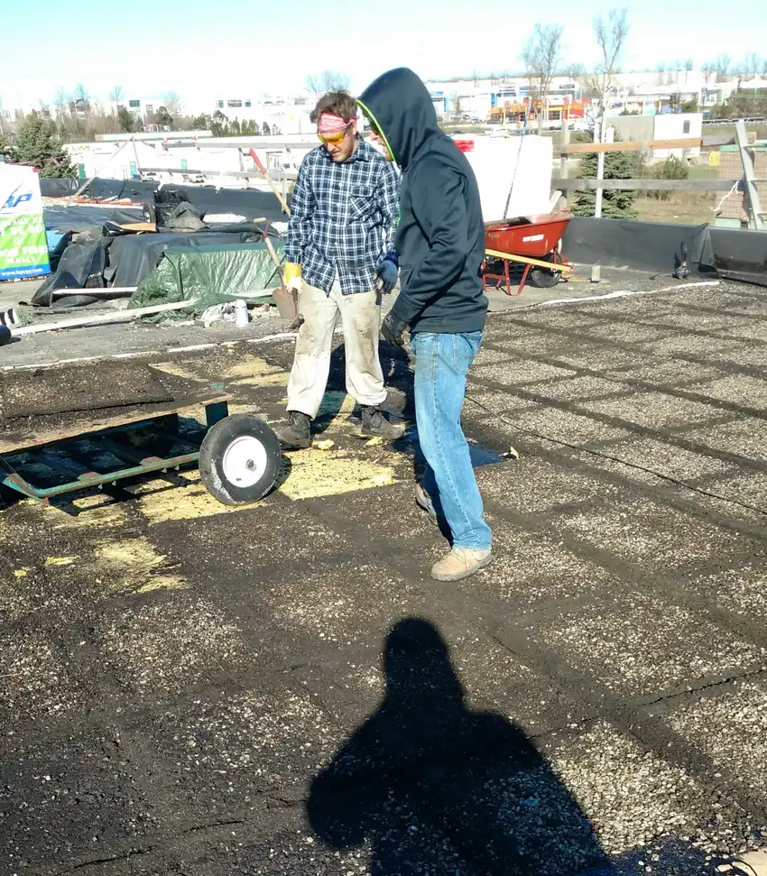 Old roofing being removed down to the deck
